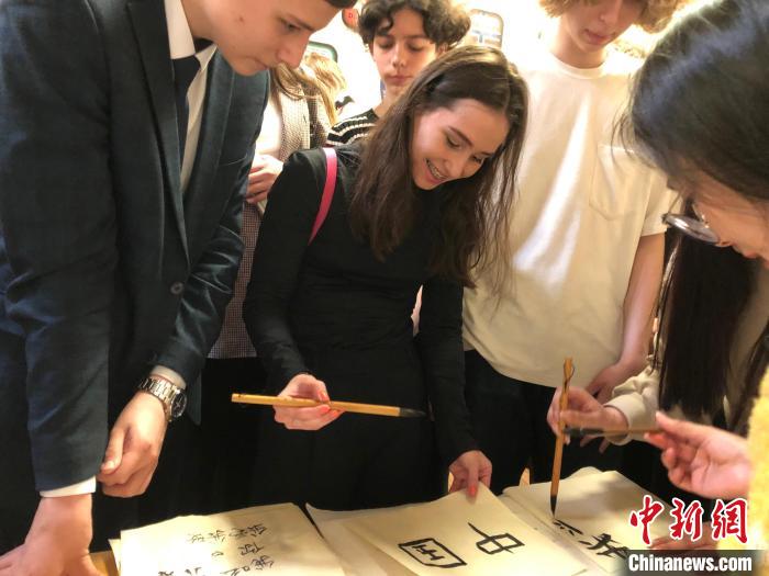 4月21日，莫斯科國立語言大學孔子學院附屬中學舉(ju) 辦“國際中文日”活動，學生們(men) 學寫(xie) 漢字。　莫斯科國立語言大學孔子學院 供圖