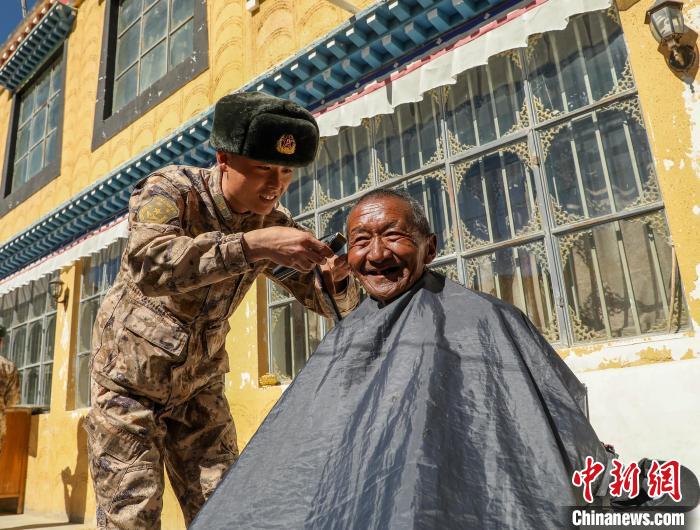 圖為(wei) 阿裏軍(jun) 分區某邊防團官兵為(wei) 駐地群眾(zhong) 理發迎藏曆新年。　旦增倫(lun) 珠 攝