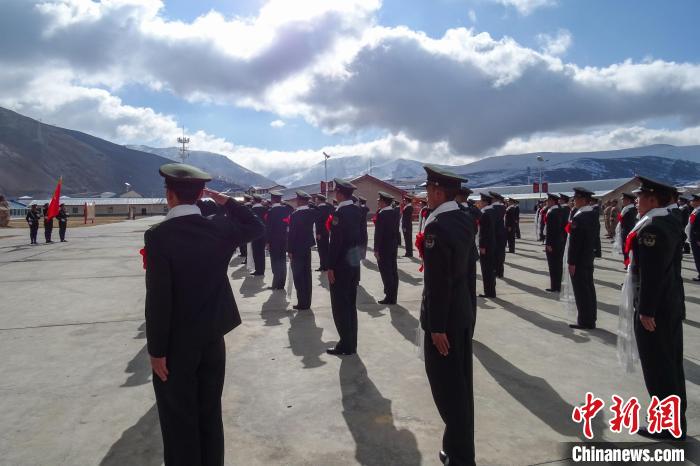 雪山下，退役士兵向軍(jun) 旗敬軍(jun) 禮。　李學文 攝